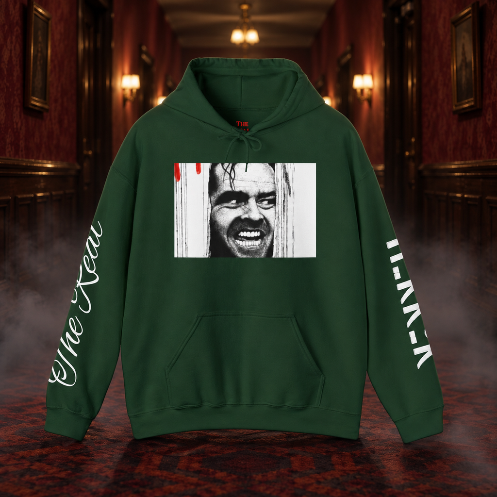 Forest green Johnny's Gone Crazy Hoodie with door-grin chest artwork and white sleeve prints, shown in a cinematic hotel corridor mockup.